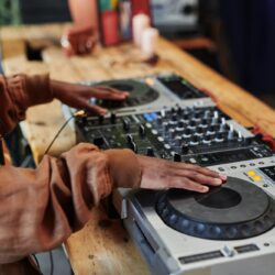 Hands of black man creating new music and recording it for entertainment event